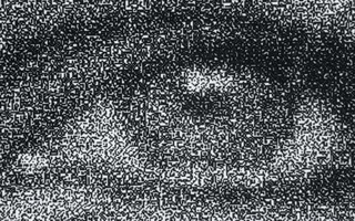 Enlarged view of print that focuses on the dots that make up one of the person's eyes.