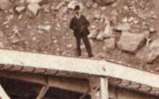 Enlarged view that focuses on a man standing on the bridge.