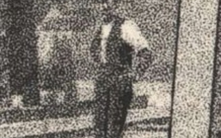 Closeup on the man standing on train tracks.