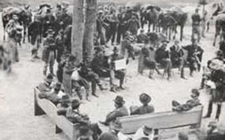 A group of soldiers sitting on benches.