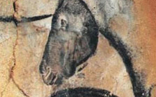 Pigment print of black horses on a cave wall.